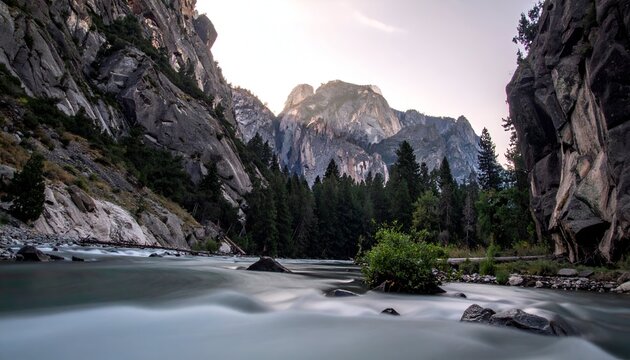 Majestic mountain landscape with river flowing through a rocky canyon.