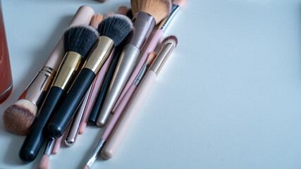 Assorted makeup brushes on minimal modern desk