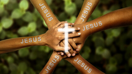 Human hands with Jesus text joined together and centered with a glowing Christian cross. Concept of Christianity, religious, faith, Jesus, or belief