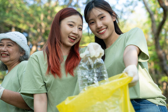 Volunteers show social responsibility by working together to recycle plastic, creating friendly community. Their teamwork help support sustainable environment for future generations. Volunteer concept - Powered by Adobe