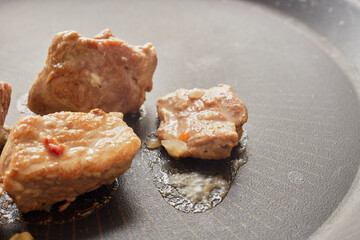 Close-up of stewed beef meat in a frying pan