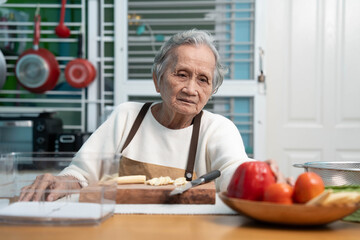 Elderly people are cooking in the kitchen at home.