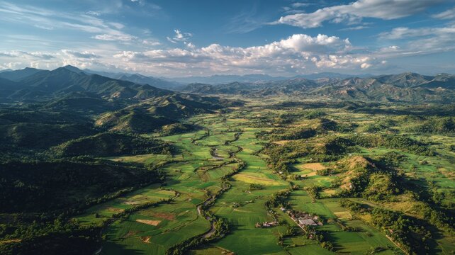 Aerial view of lush green fields and rolling hills with scenic natural landscapes under soft sunlight, capturing the beauty of open countryside and serene outdoor environment - Powered by Adobe
