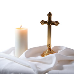 A softly lit candle and golden cross rest on a draped white cloth