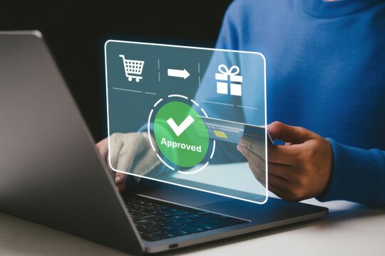 Online shopping purchase payment approved using laptop and credit card for secure transaction process now