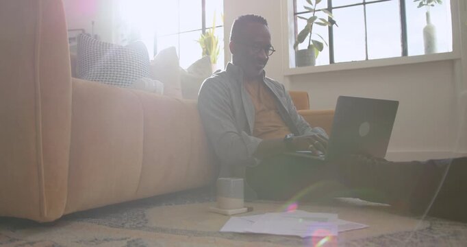 Mid Adult Man Working from Home Looking at Paper Finical Statements