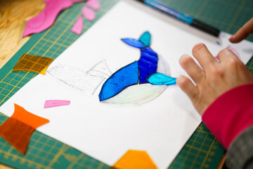 Making stained glass during artistic workshop. 