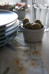 olives served table catering family dinner lunch guests waiting table setting utensils authentic cozy atmosphere vegetables