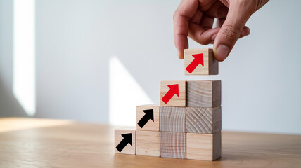 Progressing to new heights, hand places arrow block staircase