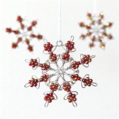 DIY snowflake ornaments made from beads and wire hanging on minimal festive background