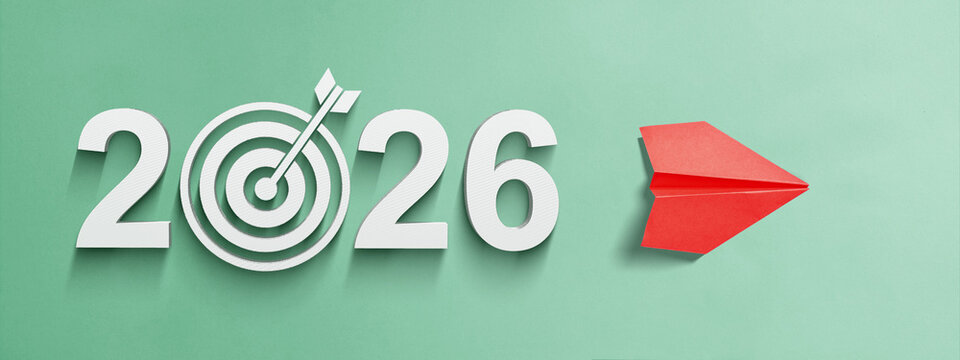 Number 2026 with an arrow on a target board and a paper airplane on a colored background. Happy New Year concept or Celebration. 2026 Goal Target