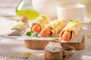 Unhealthy hot dogs with cheese and puff pastry.