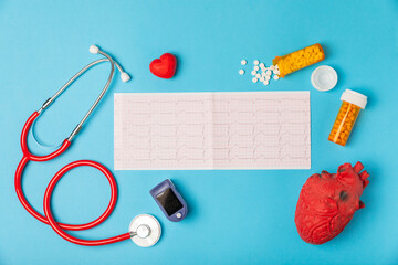 Medical stethoscope, red heart, and cardiogram on a color background. ECG, Heart wave, heart attack, cardiogram report. Cardiogram pulse trace and heart concept. Healthcare.Space for text