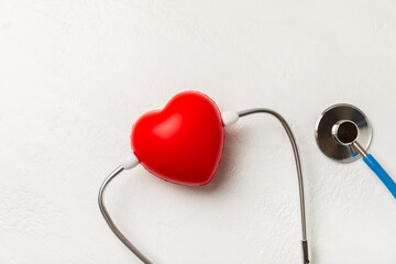 Medical stethoscope, red heart, and cardiogram on a color background. ECG, Heart wave, heart attack, cardiogram report. Cardiogram pulse trace and heart concept. Healthcare.Space for text