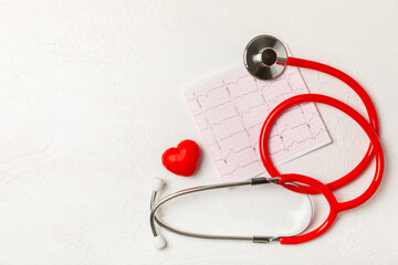 Medical stethoscope, red heart, and cardiogram on a color background. ECG, Heart wave, heart attack, cardiogram report. Cardiogram pulse trace and heart concept. Healthcare.Space for text