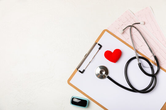 Medical stethoscope, red heart, and cardiogram on a color background. ECG, Heart wave, heart attack, cardiogram report. Cardiogram pulse trace and heart concept. Healthcare.Space for text - Powered by Adobe