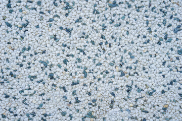 light white and pale blue exposed aggregate surface texture with speckled gray and black pebbles, detailed uniform construction background, concept of building material, architecture, exterior design