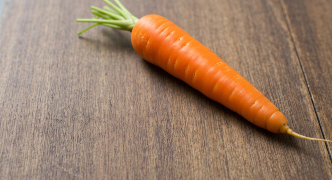 Fresh organic carrot vegetable with vibrant orange color, natural root, farm-fresh produce, healthy snack, nutritious ingredient, and versatile culinary use