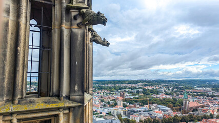 Close-up photo of stone gargoyle on tower of Ulm Minster in Germany