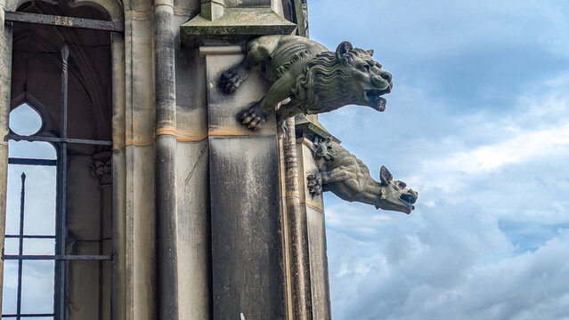 Close-up photo of stone gargoyle on tower of Ulm Minster in Germany - Powered by Adobe