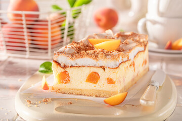 Delicious and tasty peach cheesecake with meringue, foam and fruits.