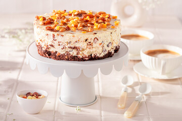 Delicious cheesecake served with coffee on white countertop.