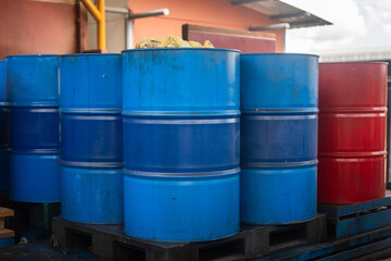 Old used chemical or oil barrel with unknow type of chemical contained that keeing at chemical storage place. Industrial object, close-up.