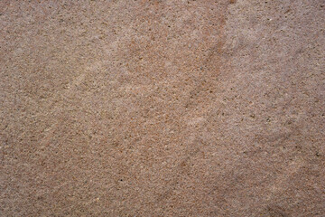 fine grained tan brown sand or concrete surface texture with subtle darker stain, detailed earth tone construction background, concept of building material, architecture, aged flooring