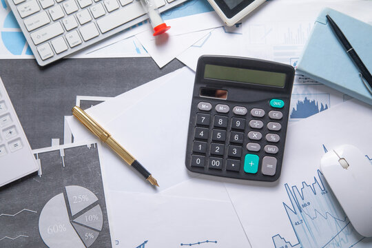 Pen and calculator on a financial graphs. Business