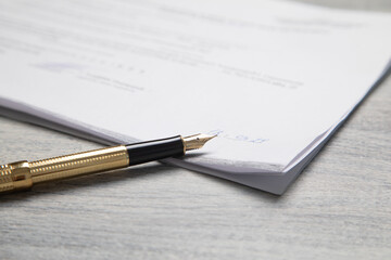 Pen and contract on the table.