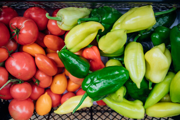 Ripe green pepper and red tomato, collected in a box. Autumn harvest.