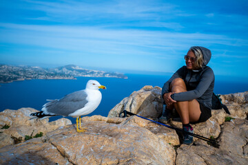 Female Hiker on the Summit of Peñón de Ifach, Calpe, with a Panoramic View of the Mediterranean Sea