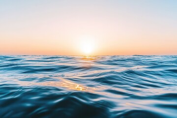 Fototapeta premium Gentle ocean waves at sunset with soft light reflecting on the water surface