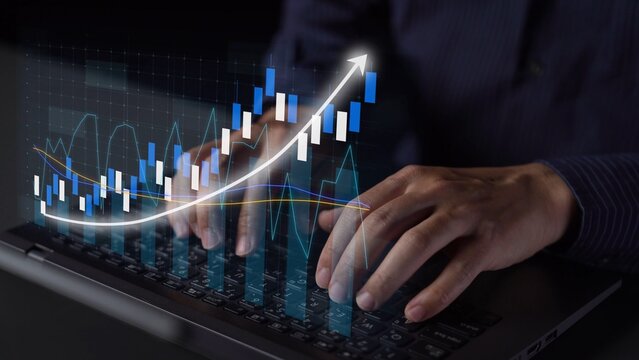 A close-up view of hands typing on a laptop keyboard, featuring an overlay of a rising growth graph, symbolizing data analysis and modern finance in business. Copula