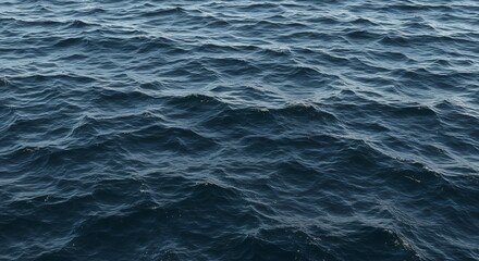 Obraz premium Deep blue ocean surface ripples with sunlight glimmering across the gentle waves