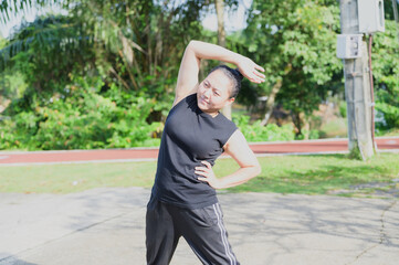 Asian Woman Stretching in Park for Healthy Lifestyle and Wellbeing