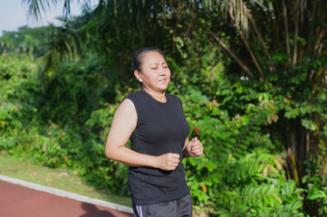 Asian Woman Running Outdoors for Health, Fitness, and Wellbeing