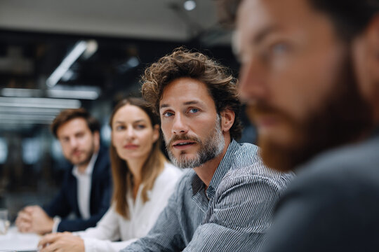 Team of professionals presenting ideas in a boardroom. - Powered by Adobe