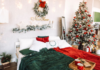 Cozy bedroom decorated for New Year celebration, featuring a festive tree, colorful blankets, and holiday wreath, creating a warm and inviting atmosphere for winter festivities