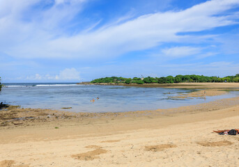 Beach with a body of water in the background