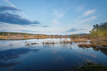 Calm lake with a cloudy sky in the background