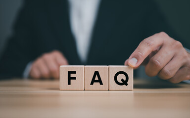 Businessman's hand is placing wooden blocks that spell out 