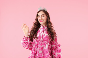 Beautiful woman wearing luxury crown on pink background