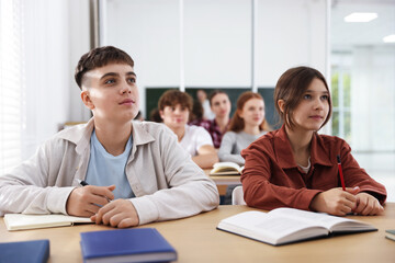 Fototapeta premium Teacher and students during lesson in classroom, selective focus