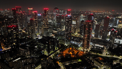 Aerial drone night shot of iconic illuminated modern skyscraper complex of Canary Wharf , London,...