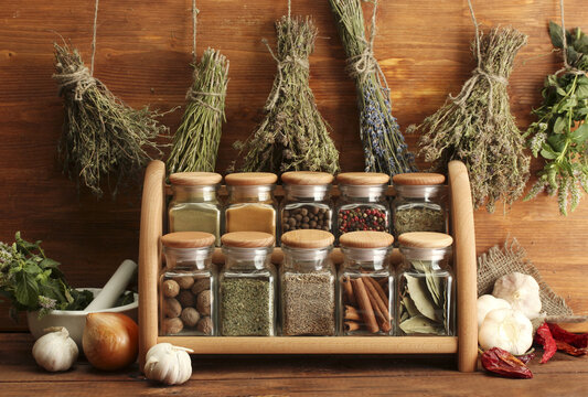 Dried herbs, spices and and pepper, on wooden background
