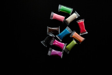 Children's colorful plasticine on displayed on a dark surface ready for artistic projects