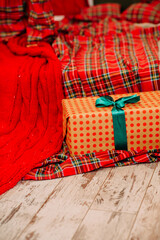 Christmas Gift Box on Plaid and Wooden Floor