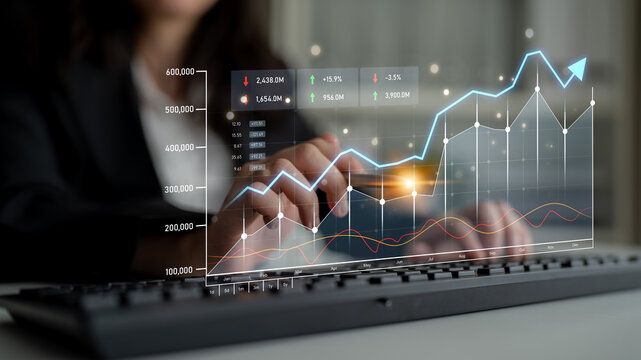 A business expert analyzes dynamic financial data on a digital interface, showcasing trends and growth in a modern office setting with a keyboard. Scalp