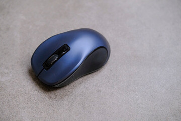 Dark computer mouse on gray desktop